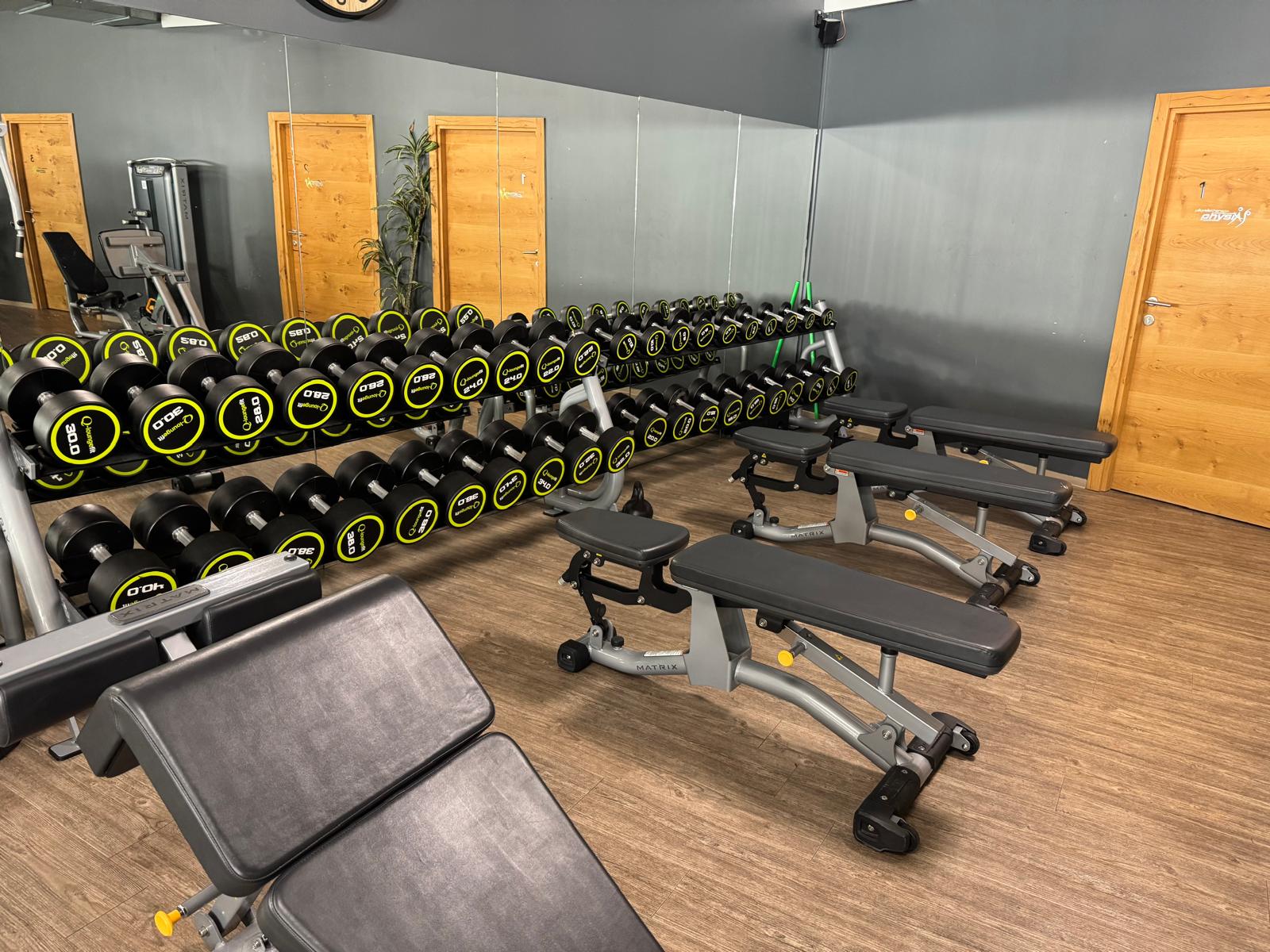 Freihantelbereich mit Kurzhanteln und Bänken im Fitnessstudio – fit+ Steinach